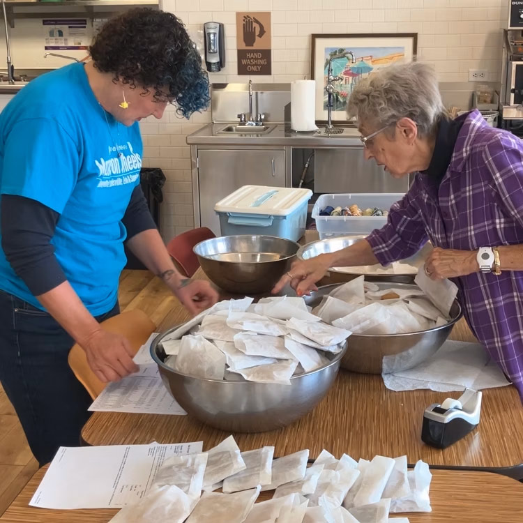 Coal Creek Volunteer packing meals